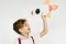 The image shows a little boy with a paper rocket.