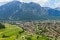 The picture shows a small town in a valley surrounded by nature and mountains as a symbol of sustainability.