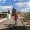 The picture shows a female cyclist on a sunny day.
