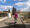 The image shows a woman on a bicycle.