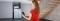 The image shows a woman operating her Viessmann heating system via app.