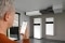 The image shows a man holding a smartphone, which he uses to control Viessmann systems via an app.