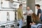 The image shows a group of people in front of radiators.