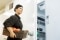 The image shows a chef opening a industrial fridge