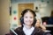 Young girl sitting in classroom wearing headphones